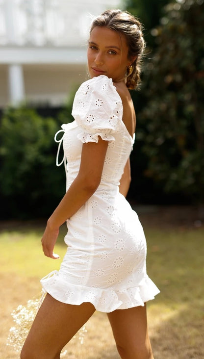 Womens White Eyelet Lace Up Mini Dress | V Neck, Puff Sleeves, Ruched Hem | noémi
